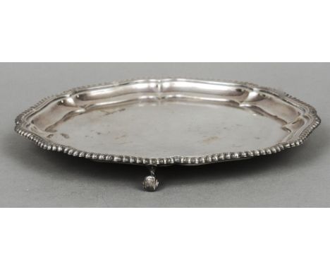 A silver salver, hallmarked Birmingham 1967, maker's mark of Walker & Hall
With shaped gadrooned rim, standing on scroll feet