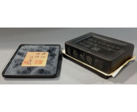 A Chinese ink block
Inscribed with calligraphic text and seal marks, housed between jade mounted hardwood base and cover.  10