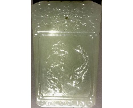 A Chinese carved jade pendant tablet
Worked with a pair of carp opposing calligraphic text.  6 cm long.  CONDITION REPORTS: G