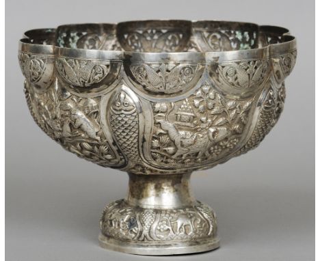 A 19th century Indian unmarked silver footed bowl
Of pierced lobed form decorated with vignettes on animals and hunting scene