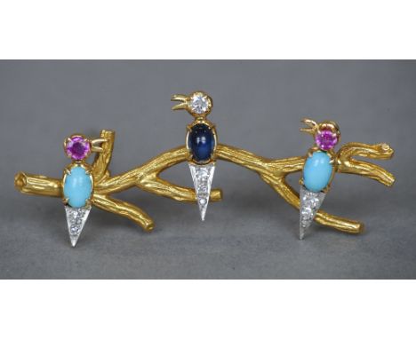 An unmarked 18 ct gold diamond, ruby, sapphire and turquoise set brooch
Formed as three birds perched on a branch.  5.5 cm wi