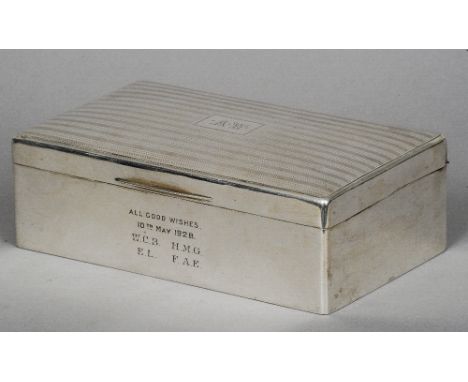 A large silver cigarette box, hallmarked Sheffield 1927, maker's mark of Walker & Hall
Of rectangular form, the hinged lid in