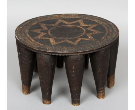 An African tribal carved hardwood stool
The circular top with geometric and star carvings.  42 cm diameter. CONDITION REPORTS