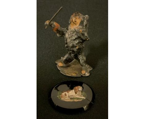 An early 20th century painted metal model, Spaniel conductor, standing holding a musical baton, indistinct marks, 6.2cm high;