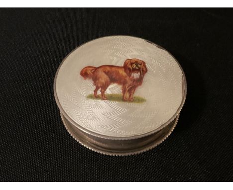 An Edwardian silver trinket box, the cover enamelled with Toy Spaniel, 5.5cm diam, Birmingham 1907 