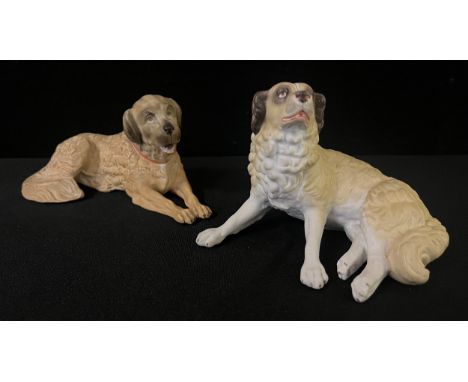 A pair of German bisque models, of St Bernards, reclining, 15cm wide, c.1910 