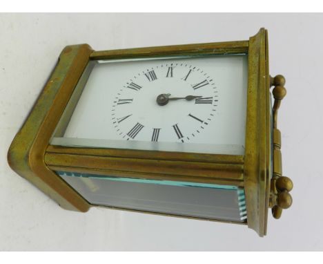 A brass carriage clock, with key