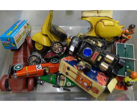 A collection of toys including clockwork, table tennis players, a battery operated robot, etc.