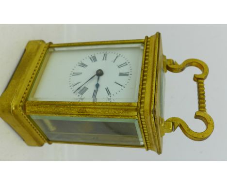 A gilt brass carriage clock, with key