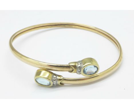 A 9ct gold, topaz and diamond bangle, 7.2g