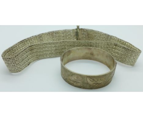 A silver bangle and a white metal necklace