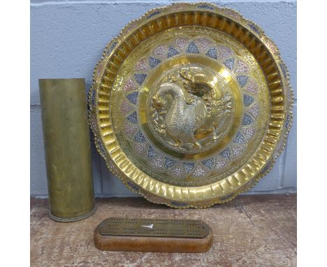 A brass military shell case, a brass tray and a cribbage marker board