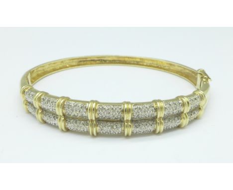A 9ct gold and diamond bangle, 15.6g, 0.50ct diamond weight