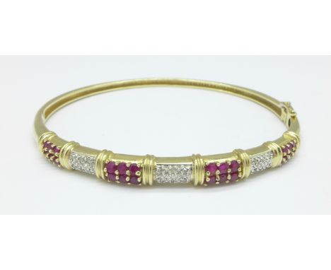 A 9ct gold, ruby and diamond bangle, 10.1g