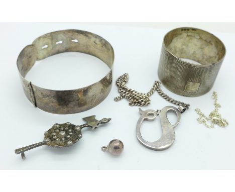 A silver bangle, a silver napkin ring, a silver Celtic brooch, lacking pin, etc.