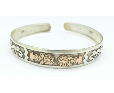 A silver and applied 18ct gold bangle