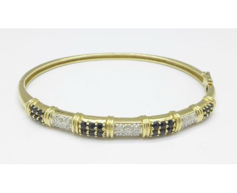 A 9ct gold, sapphire and diamond bangle, 10.7g