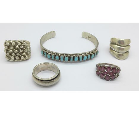 Four silver rings, one a/f, and a silver bangle