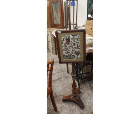 An Ealry 20th Century Fire Screen Pole with a 20th Century Embroidered scene depicting figures in earlier dress.