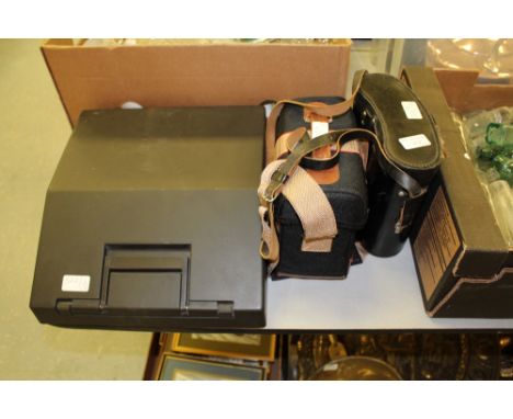 Typewriter, binoculars and camera