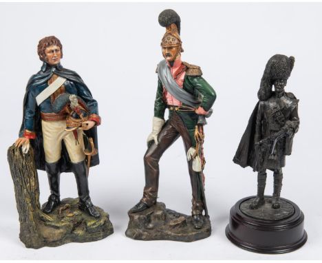 A resin figurine of a Royal Horse Guard 1815, 9½"; another of a French Napoleonic Dragoon, 10½"; also a bronzed figure of a H