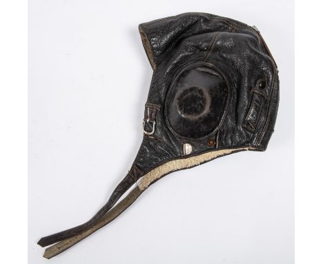 A WWII period leather flying helmet, with rubber ear cups and sheepskin lining. GC. Vendor states this is a Luftwaffe helmet.