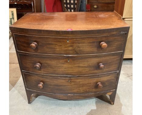 A George III mahogany bowfronted chest of three long drawers on slightly splayed bracket feet. Veneer losses.
