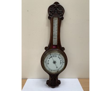An oak aneroid barometer. 32' high