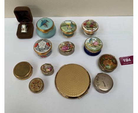 A collection of Halcyon Days and other enamel trinket and pill boxes. The lot to include a silver pill box, a silver enamel t