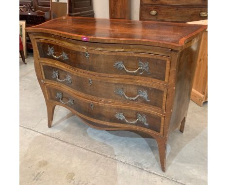 A 19th century French mahogany and crossbanded serpentine commode with a brushing slide over three long drawers on bracket fe