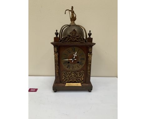 A 19th century continental walnut cased mantle clock with brass French drum lever movement striking on a coiled gong. 132 hig