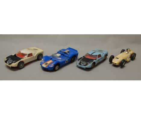 Four unboxed Scalextric cars including Offenhauser.