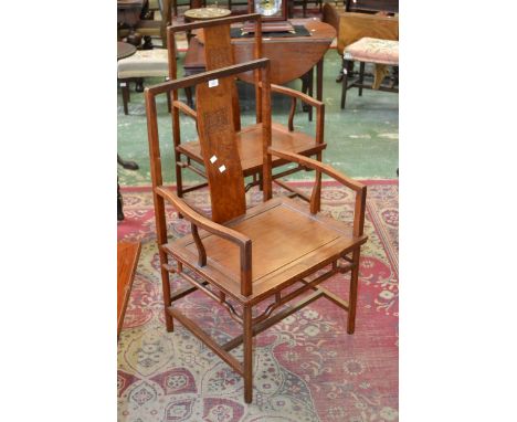 A pair of oriental hardwood armchairs, S-form splat, shaped open arms, panel seat, cylindrical supports, H-frame stretchers.