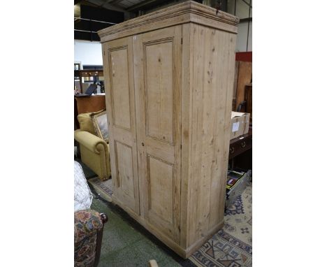 A late Victorian stripped pine hall robe, stepped cornice two panel doors, plinth base. 201cm high x 126cm wide.