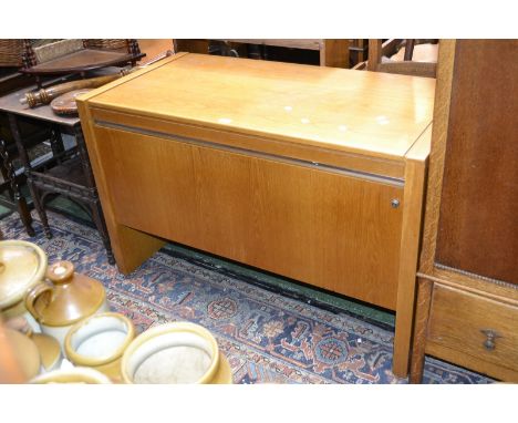 A contemporary oak veneered side cabinet, rectangular top, fall front enclosing shelf. 75cm high x 116cm wide.