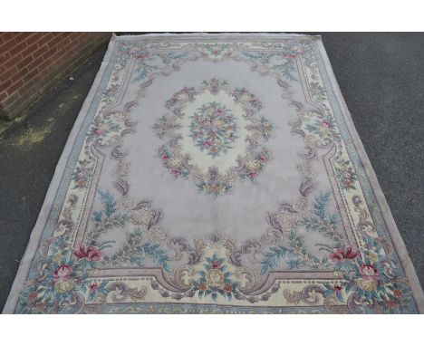 A Chinese woollen rug, floral decoration 368cm x 274cm