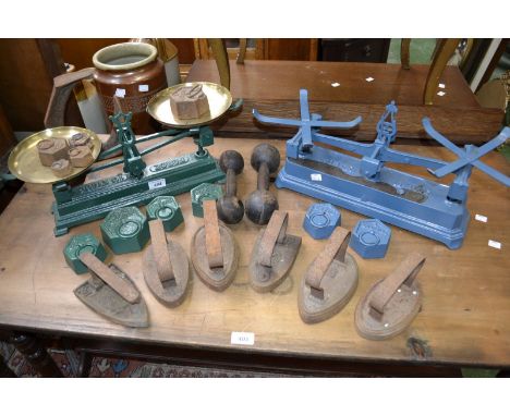 A set of early mid 20th century grocers scales, and another eleven grocer weights, an assortment of sizes, a cobblers iron, a