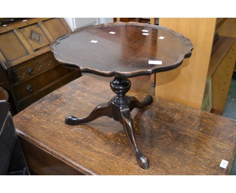 An oak tripod occasional table, piecrust circular top, fruitwood turned column, cabriole supports, pad feet; an oak standard 