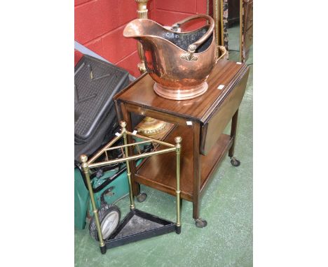 A mid 20th century mahogany tea trolley, a brass and cast iron corner stick stand, and a copper coal bucket (3)