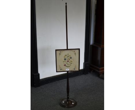 A Regency mahogany pole screen, square glazed screen with tapestry panel centre, turned column and foot