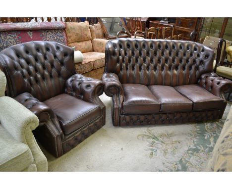 A contemporary three seat brown leather button upholstered sofa ; conforming armchair (2)