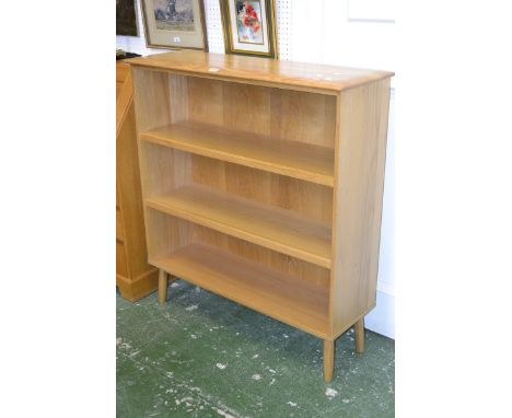 An Ercol style light oak three tier bookcase.