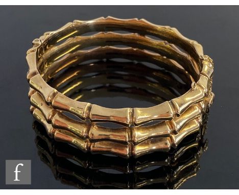 A 9ct hallmarked triple bamboo link hinged bangle terminating in tongue and box fastener, total weight 28.8g. 