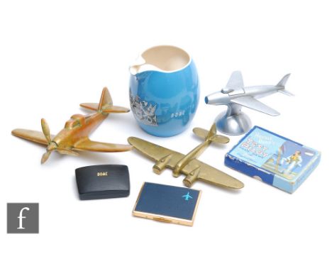 A Wade B.O.A.C pale blue water jug, a card case and lighter, a brass single propeller model aircraft, another twin engine mod