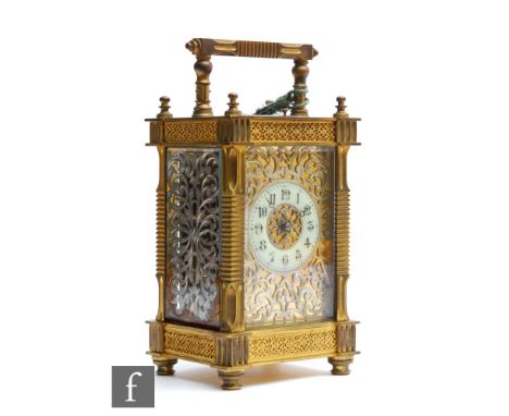 An early 20th Century French brass carriage clock with push button repeat, the Arabic dial bordered by a silvered scroll pane