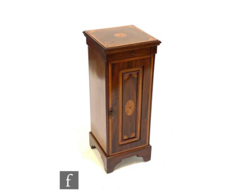 An Edwardian inlaid and satinwood cross-banded mahogany floor standing coin cabinet, the interior fitted with nineteen slidin