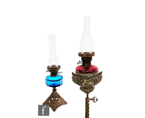 A 19th Century floor standing telescopic standard lamp and shade in the Renaissance style and a small oil lamp with blue glas