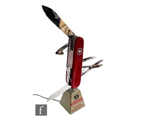 A Victorinox Swiss Army knife shop display electrically operated automaton, on grey wedge stand named ?Victorinox the Origina