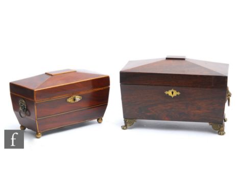 A 19th Century inlaid mahogany sarcophagul tea caddy with associated glass liner and key, on brass ball feet, width 28cm, and