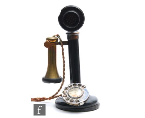 A black painted candlestick telephone with brass detachable speaker marked T E 234, no 22, height 30cm. 